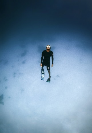 man in black jacket and black pants standing on snow covered ground