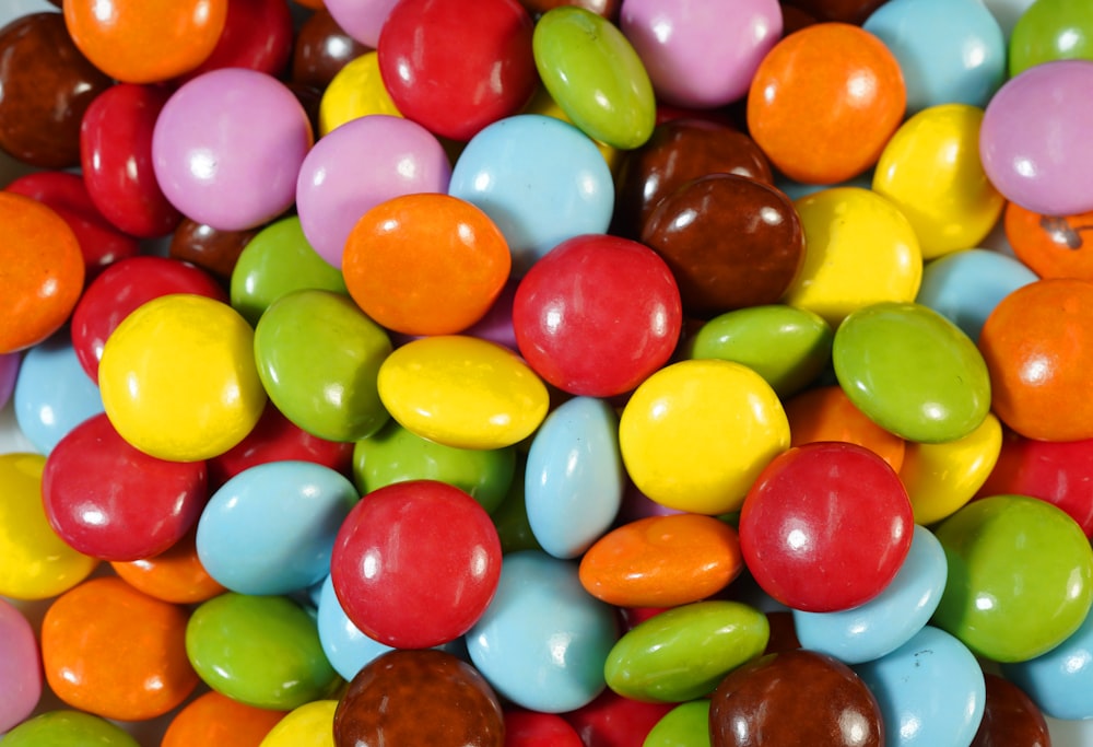 assorted color candies on brown wooden table