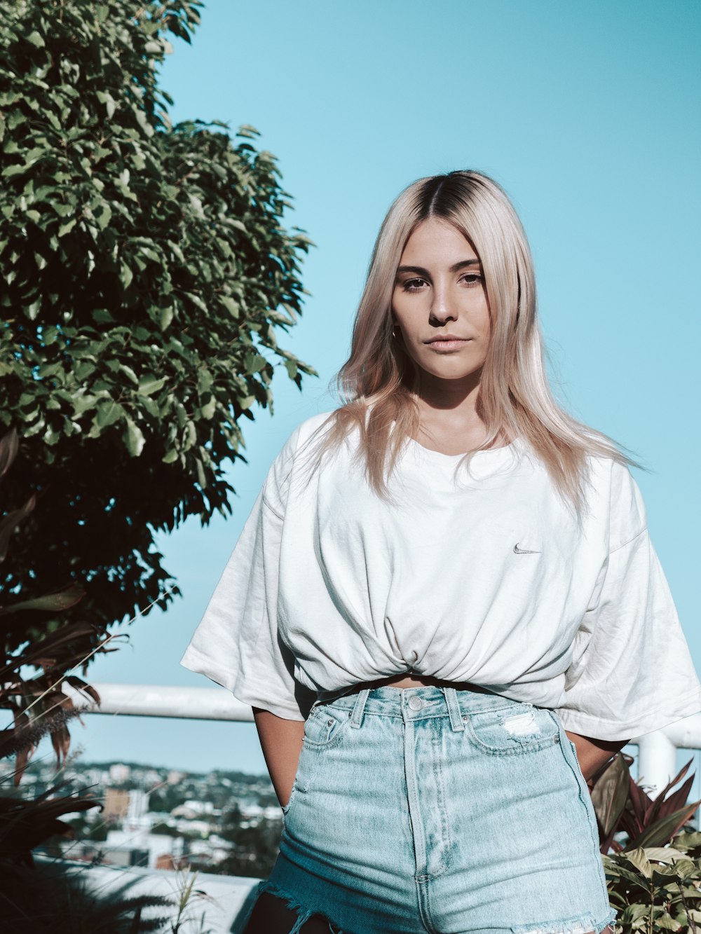 woman in white long sleeve shirt and blue denim shorts