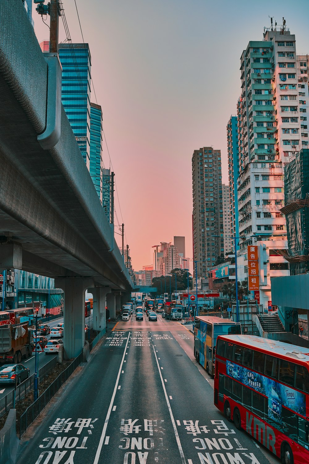 cars on road between buildings during daytime