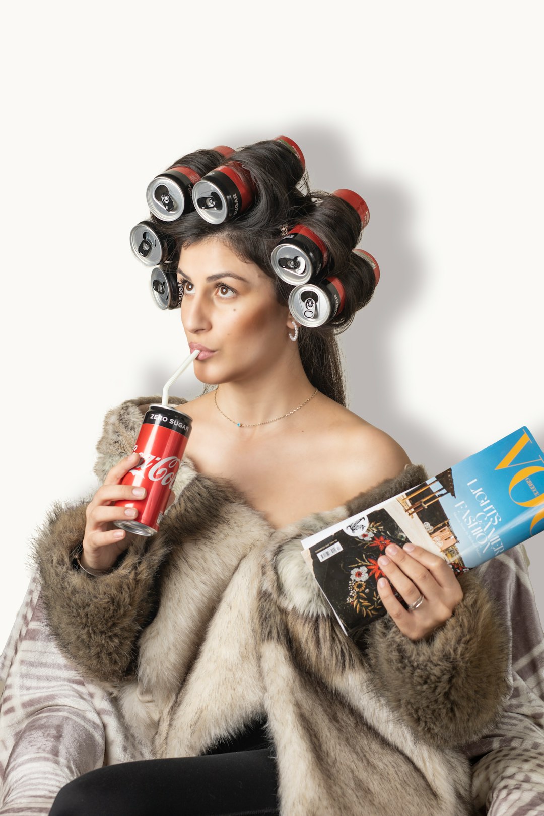 woman in brown fur coat holding red can