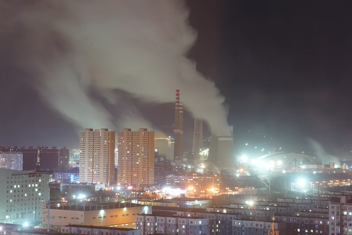 Urban night skyline with industrial smoke illustrating air pollution risk
