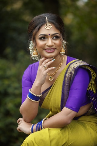 smiling woman in purple and yellow dress