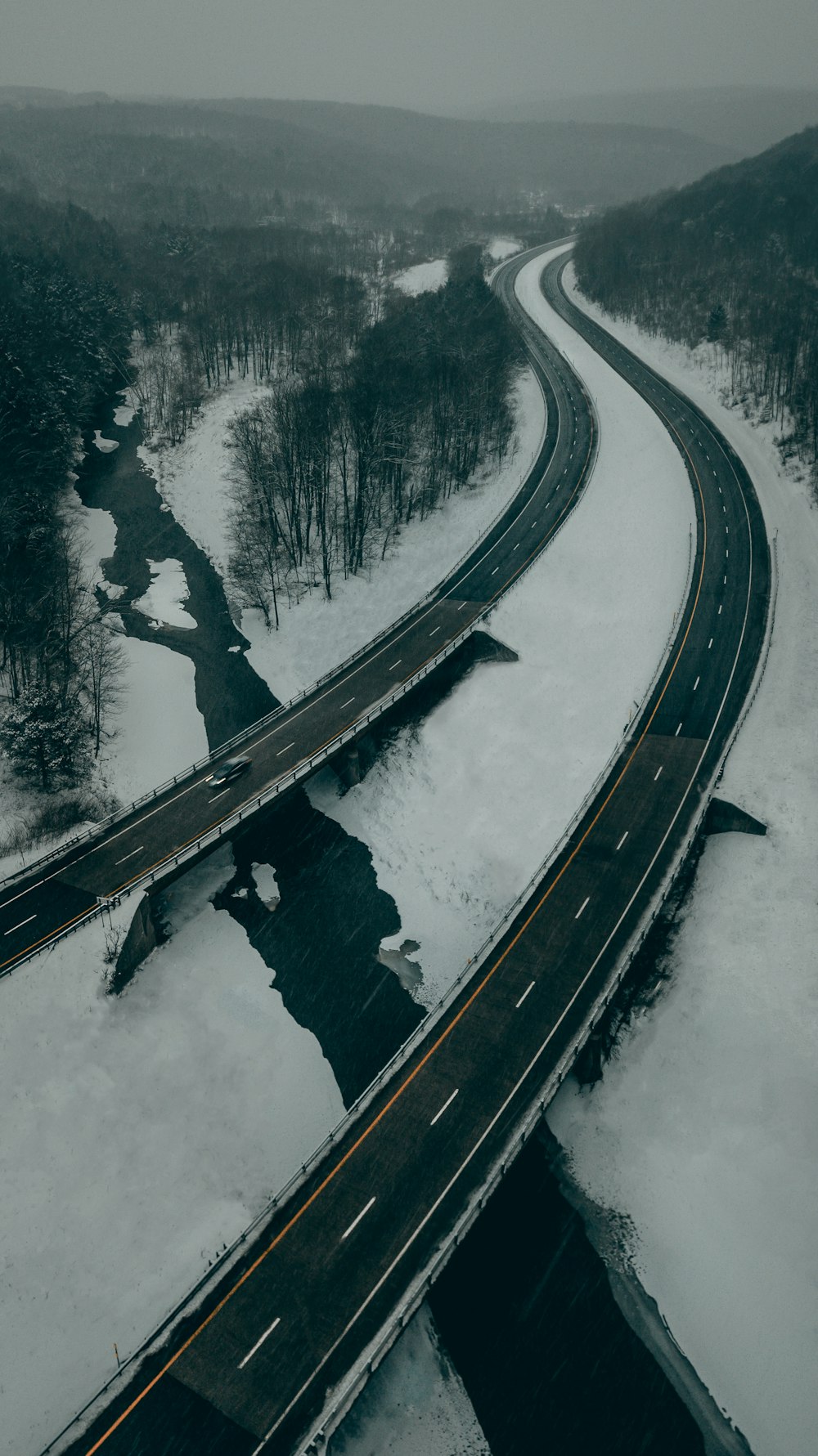 black asphalt road covered with snow