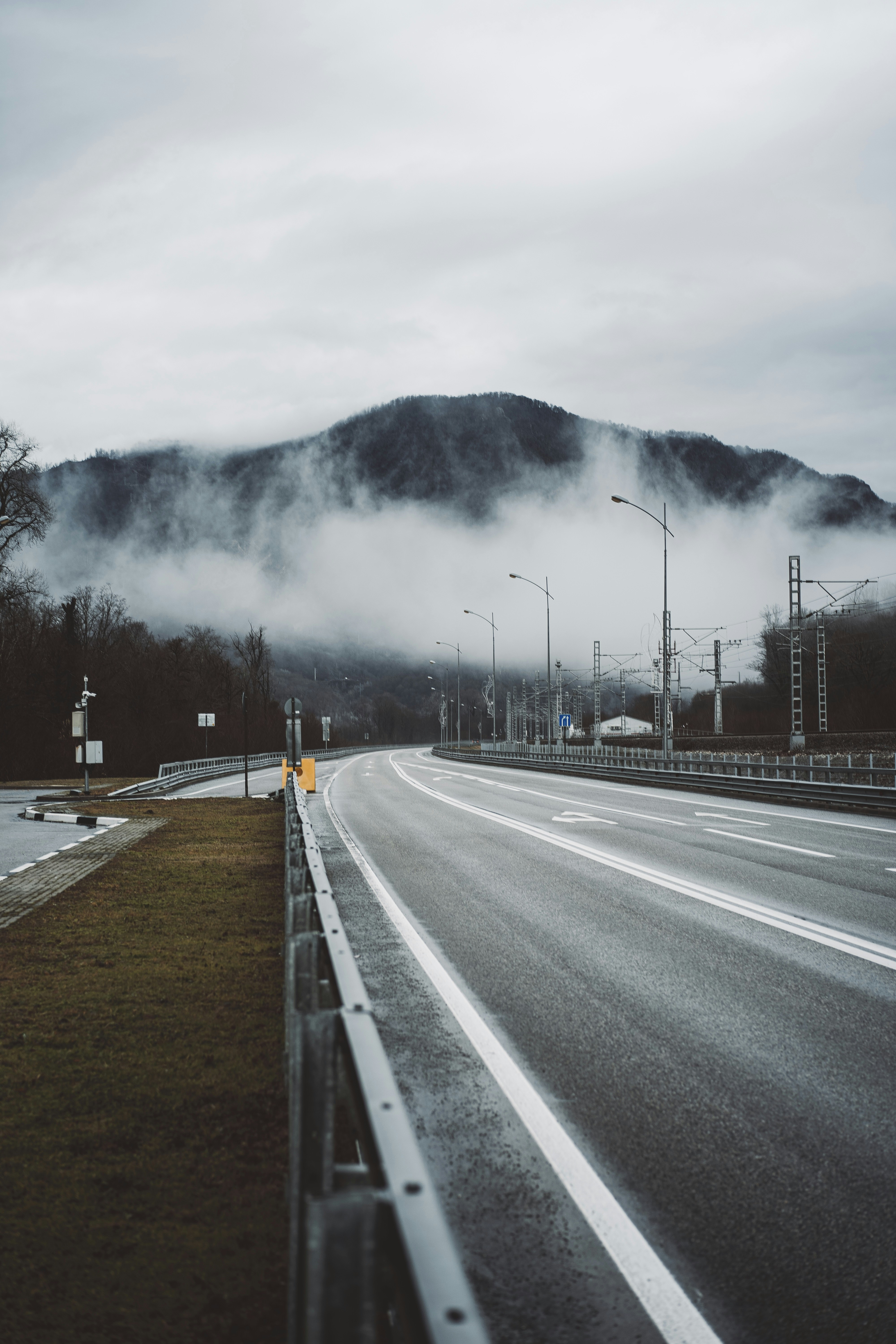 gray concrete road near mountain
