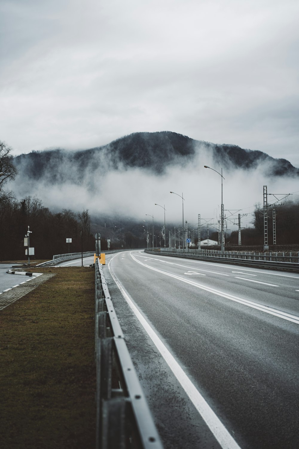gray concrete road near mountain