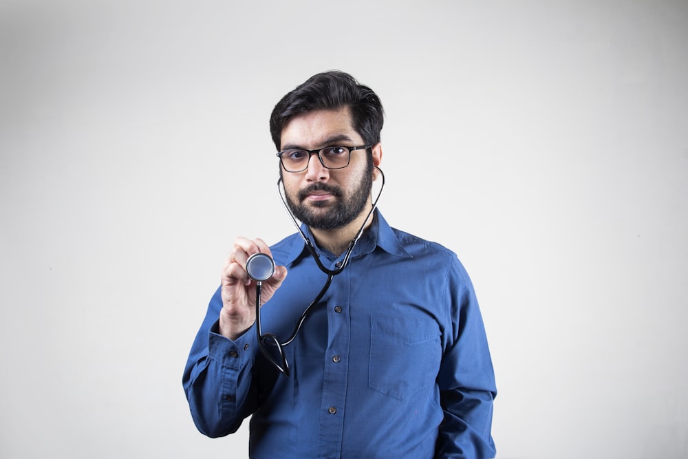 man in blue dress shirt smiling