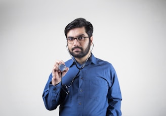 man in blue dress shirt smiling