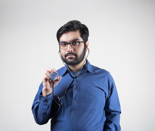 man in blue dress shirt smiling