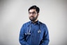 man in blue dress shirt wearing black framed eyeglasses
