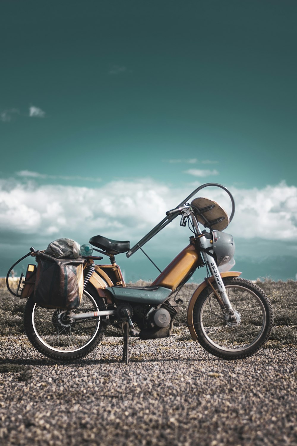 black and brown motorcycle on brown soil under blue sky during daytime