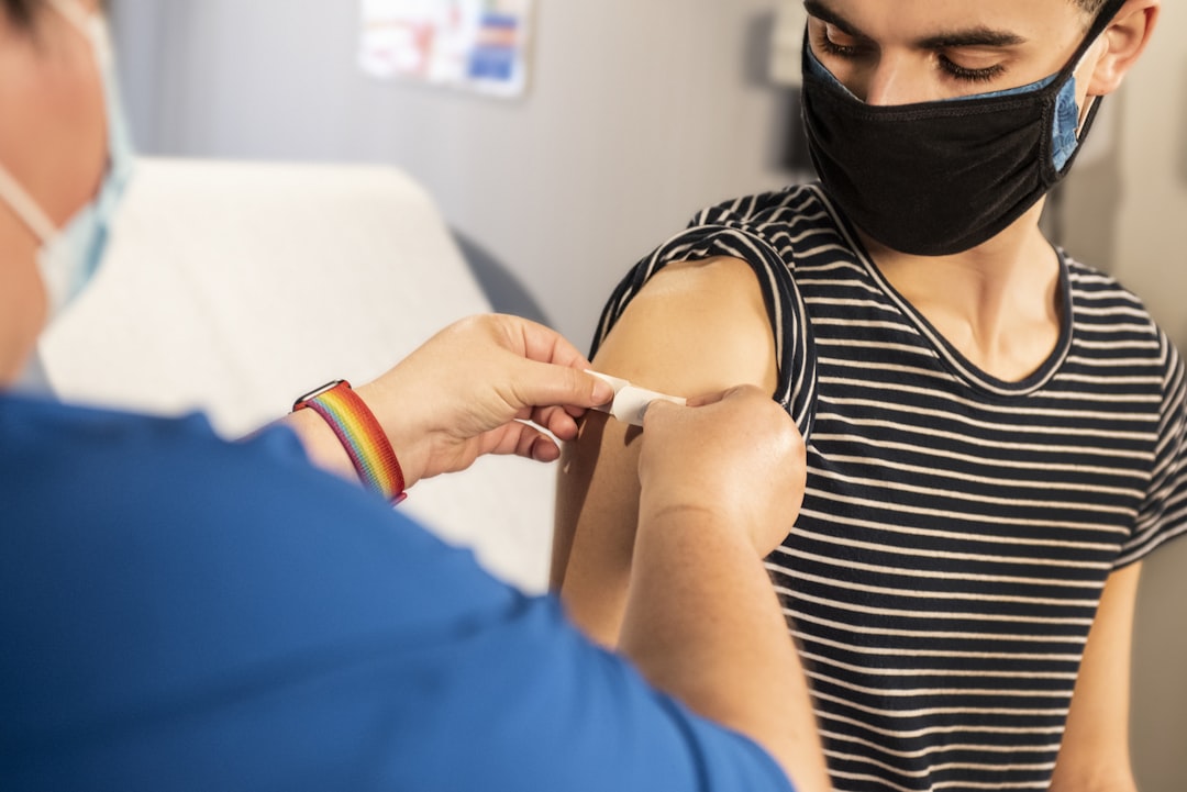 band-aid going over vaccination site of arm