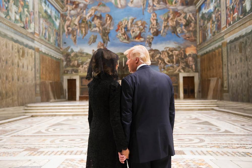 man in black suit standing beside woman in black dress