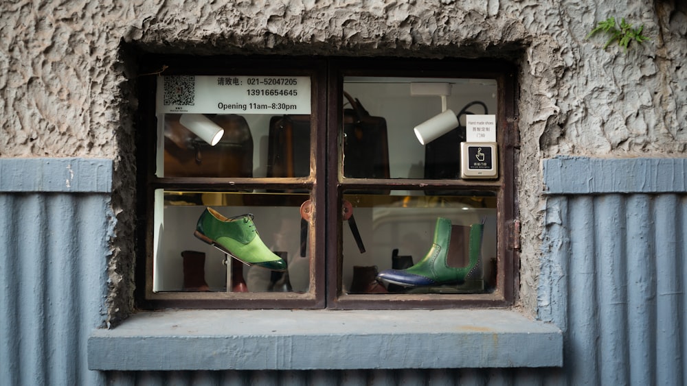 green and black leather boots on glass window