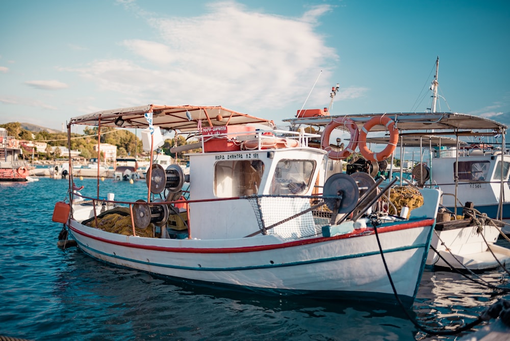 white and red boat on sea during daytime