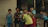 A group of kids dressed as superheroes playing together outdoors.