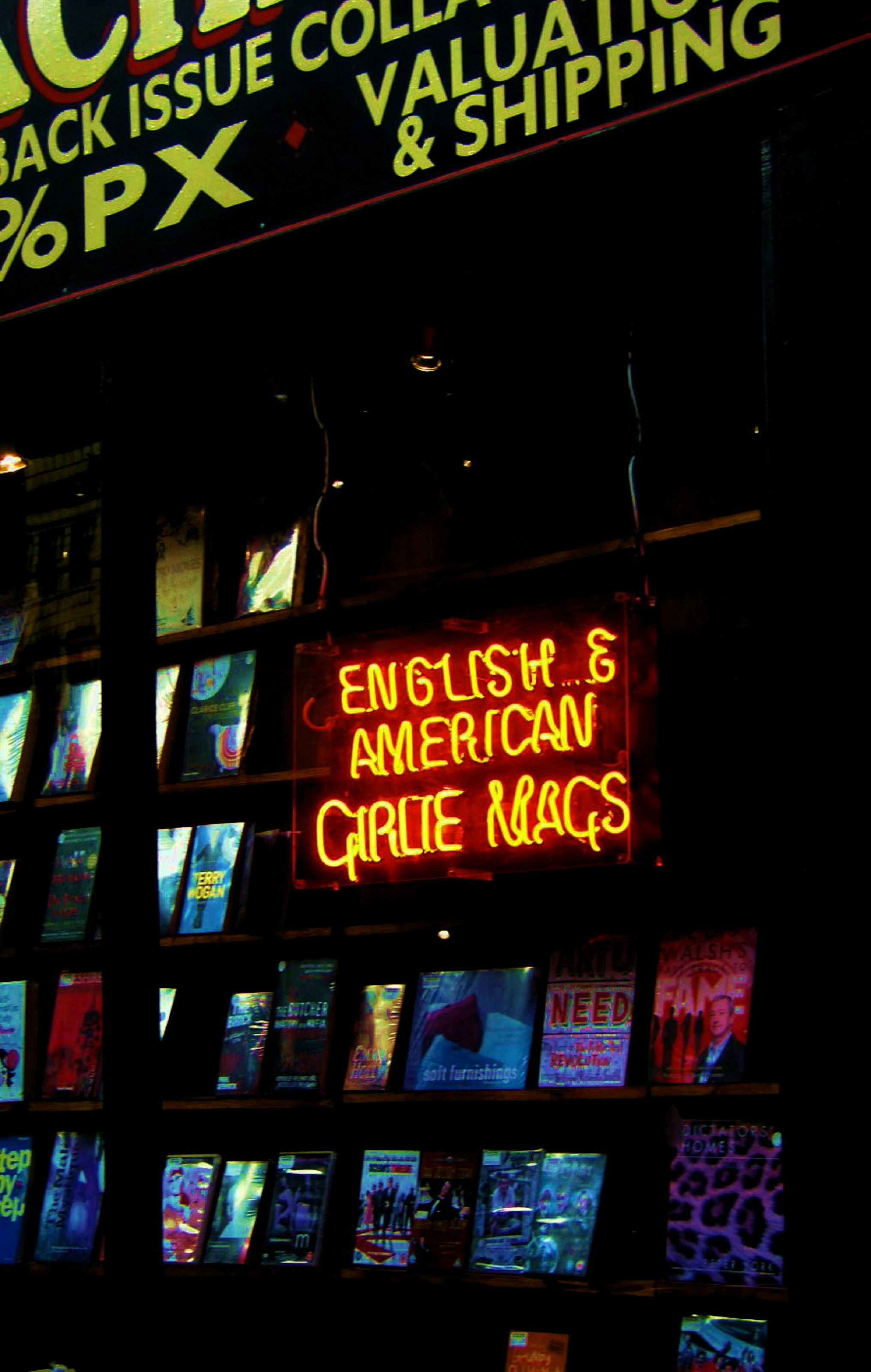 yellow and red neon porn girlie magazine sign in book store in Soho