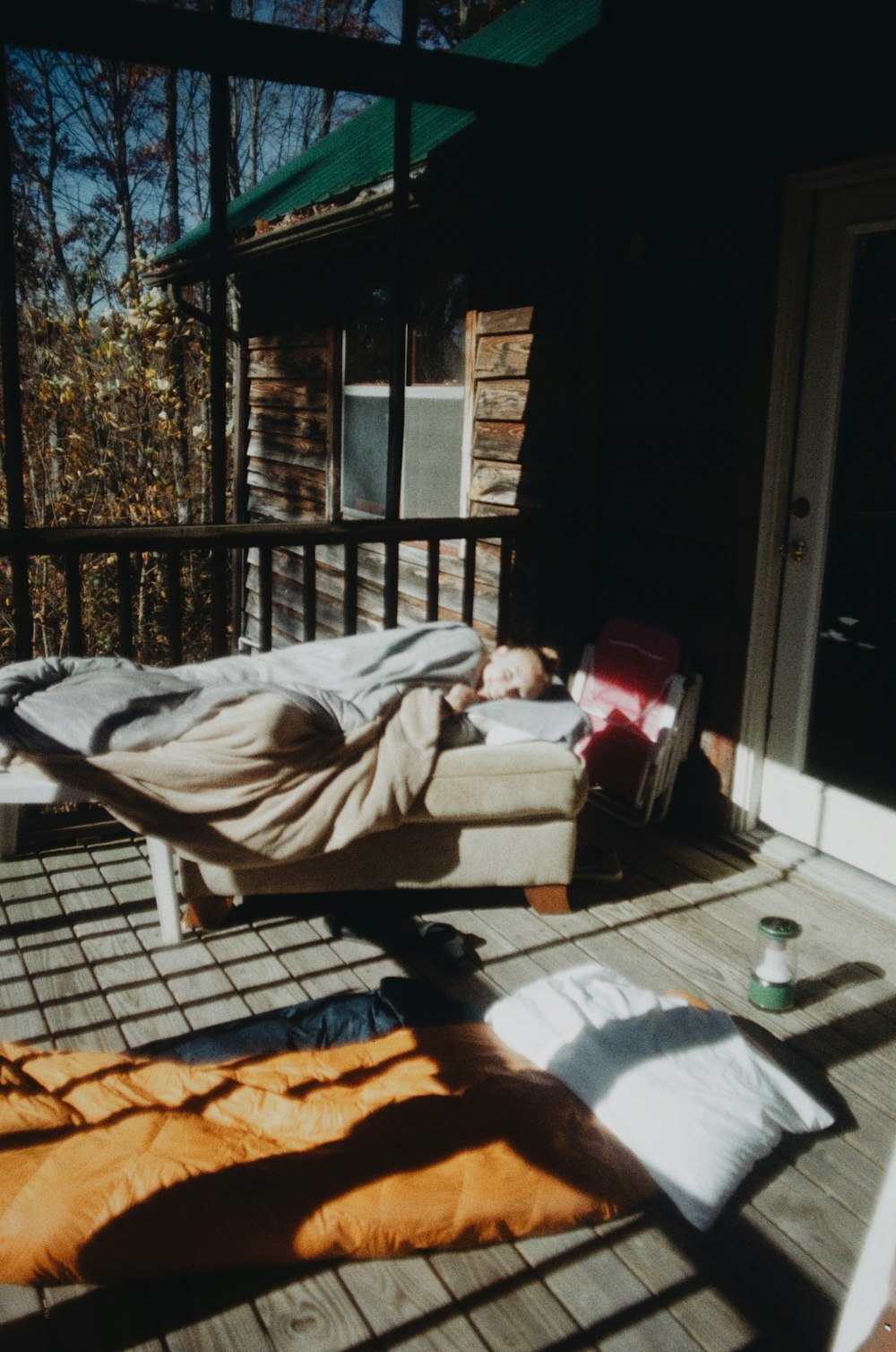 woman lying on brown wooden bench