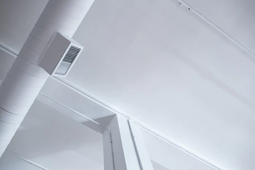 A cozy living room with a modern HVAC vent subtly integrated into the ceiling.