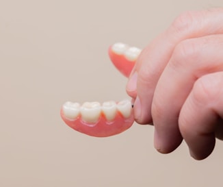 person holding pink plastic hair clip