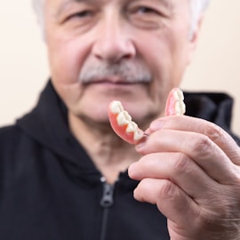 man in black shirt holding white candy