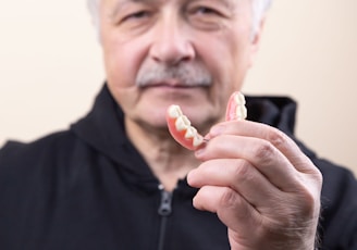 man in black shirt holding white candy