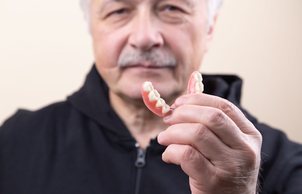 man in black shirt holding white candy