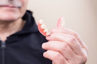 person in black hoodie holding white candy