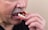A happy customer holding their new dentures with pride.