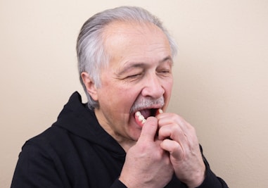 man in black hoodie Removing Dentures
