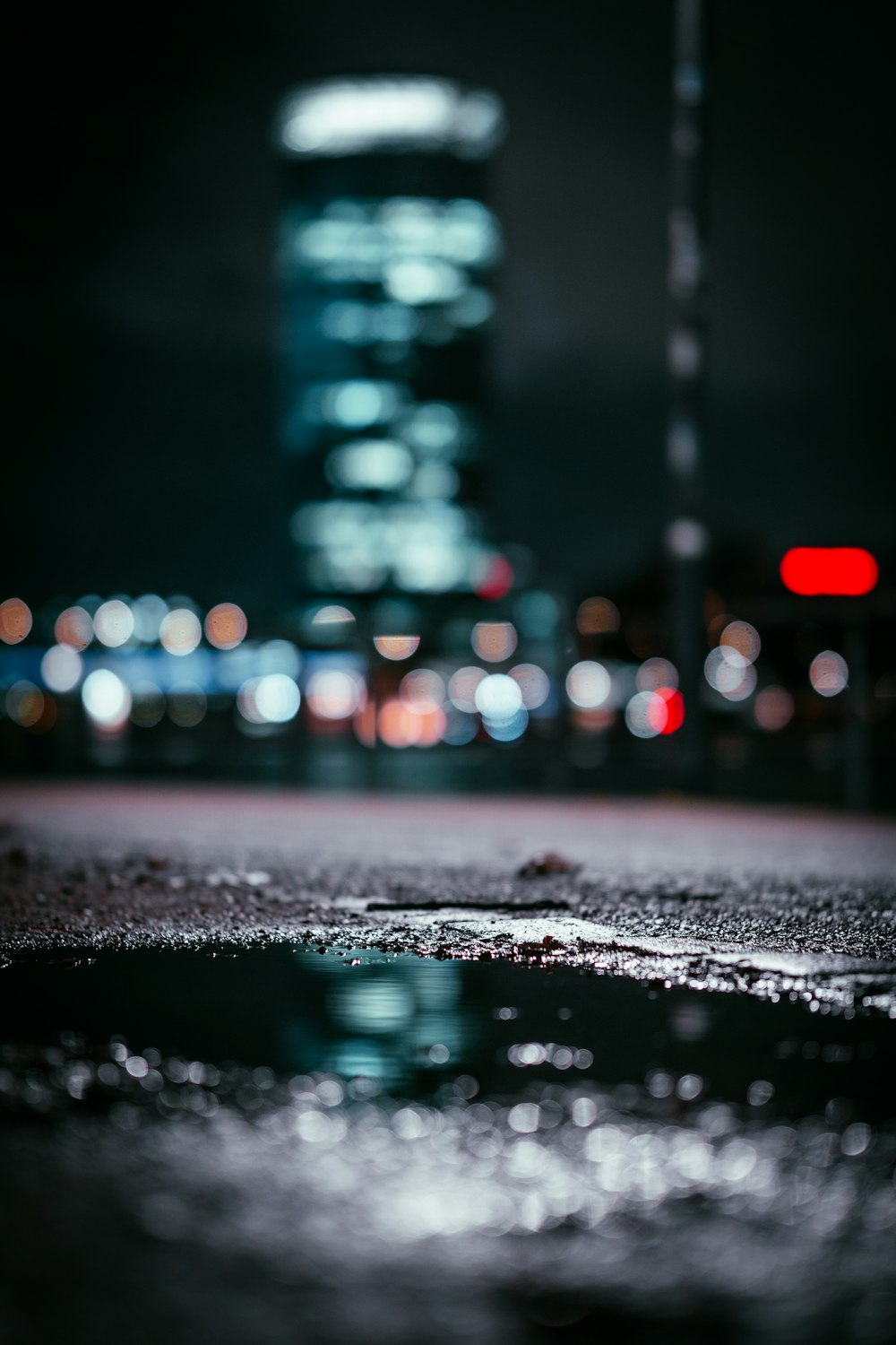 water droplets on road during night time