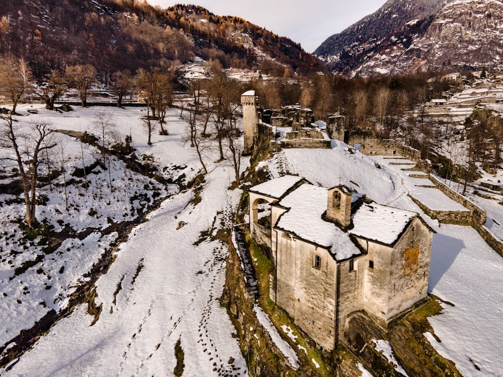 brown concrete building on snow covered ground