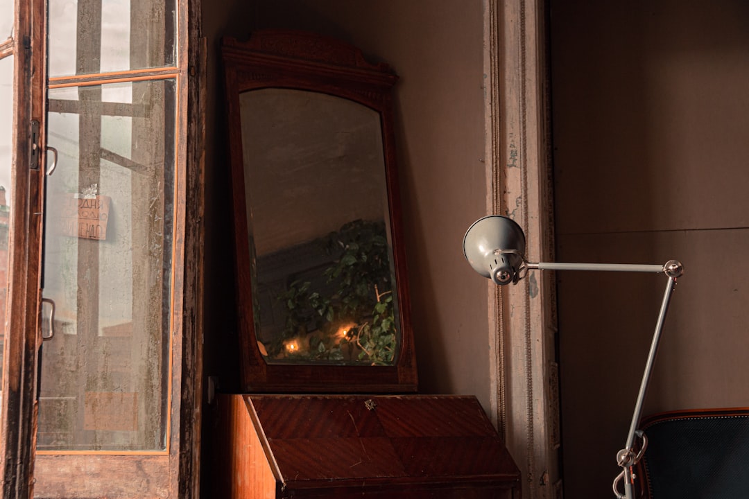 white light bulb on brown wooden window frame