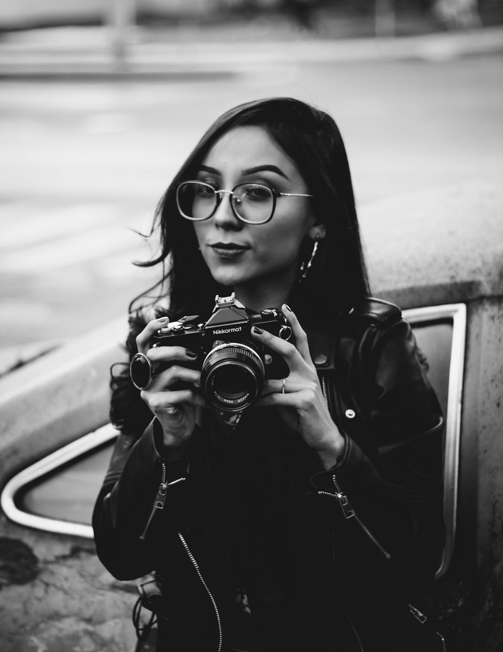 woman in black jacket holding camera