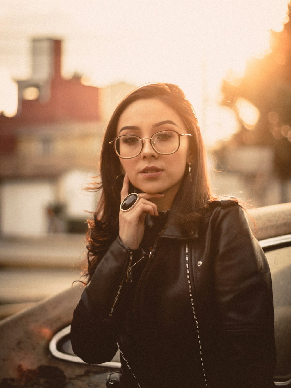 woman in black leather jacket wearing black framed eyeglasses