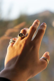person wearing silver and black ring