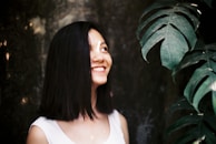 A candid shot of Monica smiling during a mentoring session, surrounded by notes and plants.