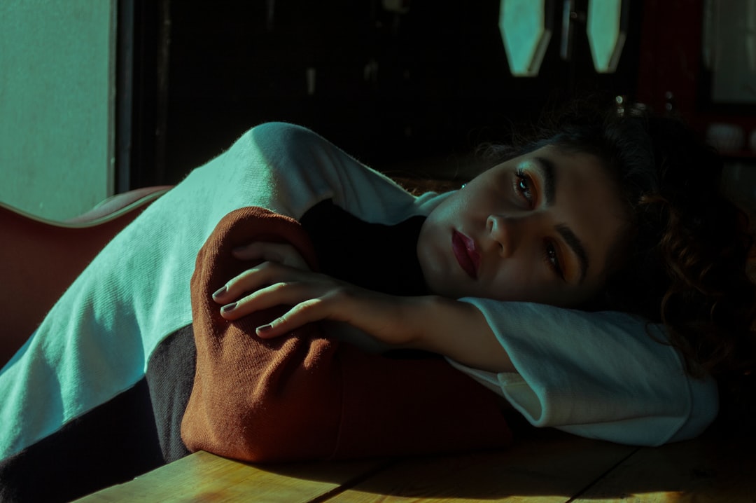 woman in black shirt lying on bed