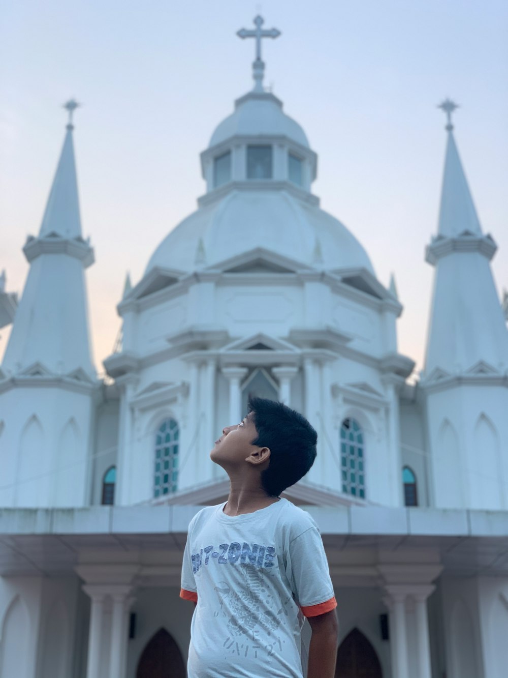 woman in white shirt standing near white cathedral