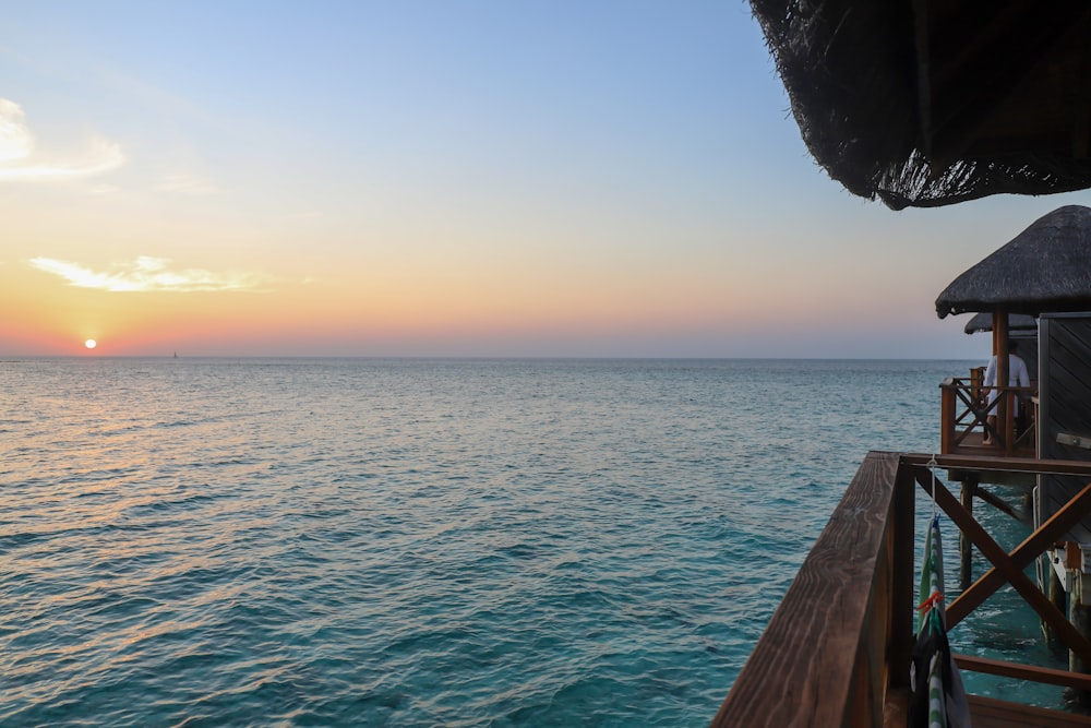 brown wooden dock over blue sea during daytime