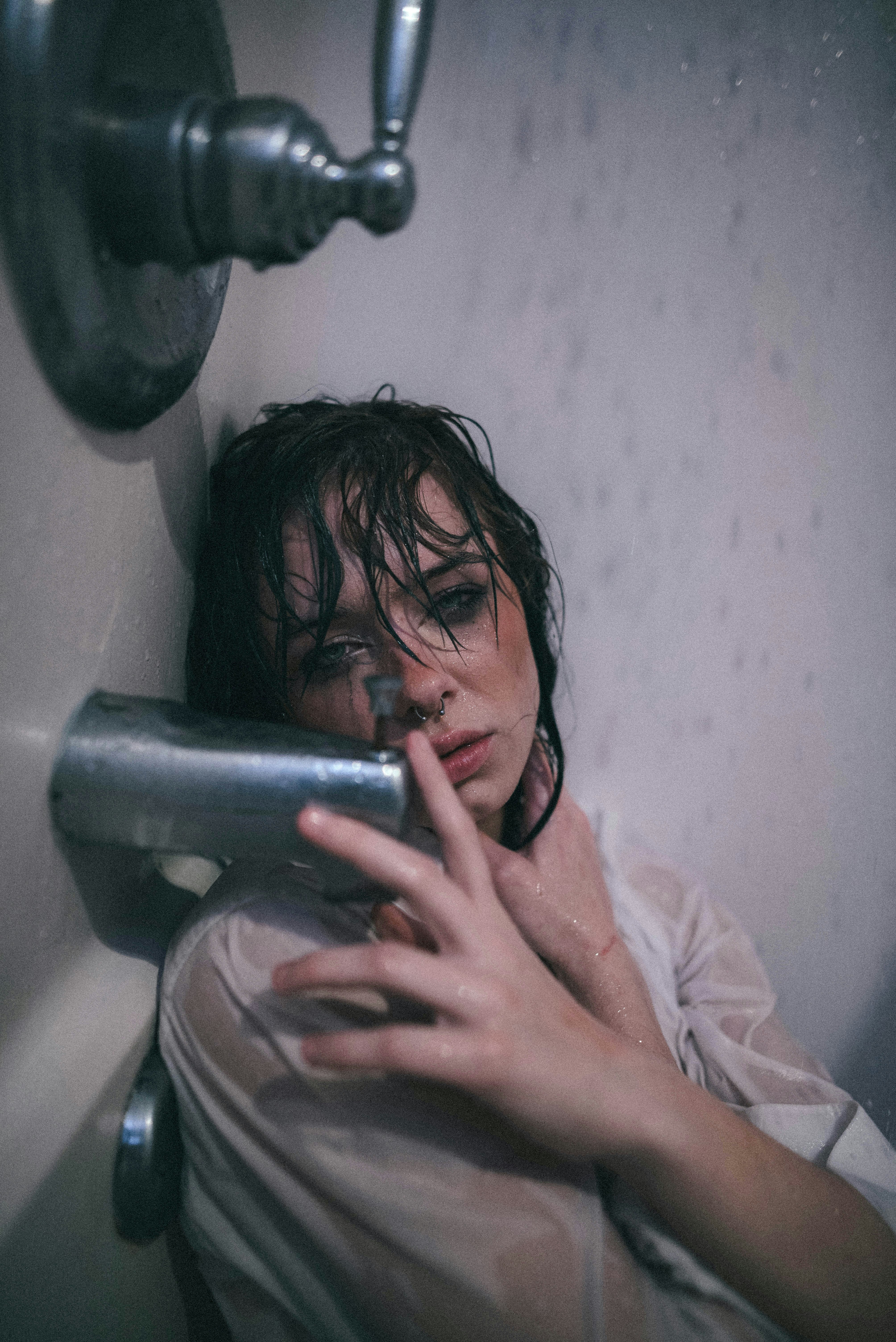 woman in pink long sleeve shirt holding stainless steel cup