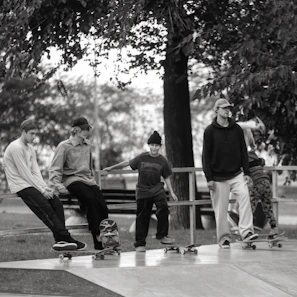Group of friends laughing and wearing different dripdash jerseys in a skate park