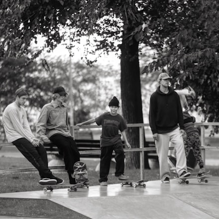 A group of diverse skaters practicing together outdoors in the Hasharon region.