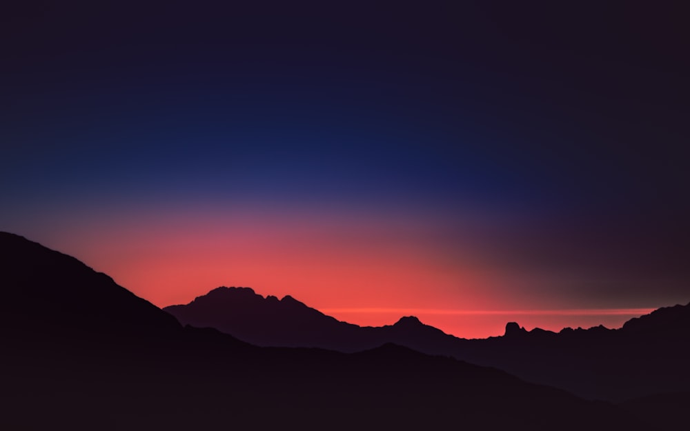 silhouette of mountains during sunset