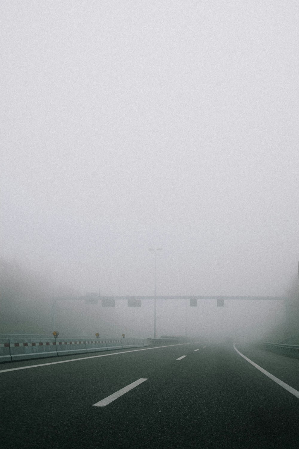 gray asphalt road during foggy weather