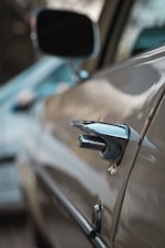 Close-up of a car door being repaired in a professional workshop.