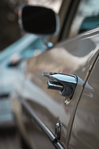 Close-up of a car door being repaired in a professional workshop.