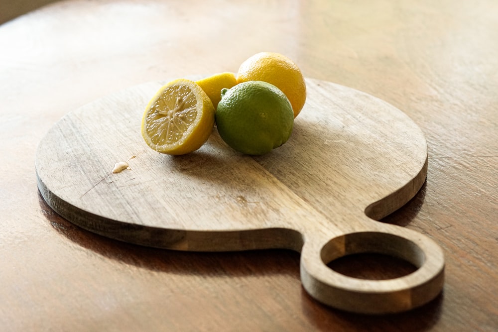 sliced lemon on brown wooden chopping board