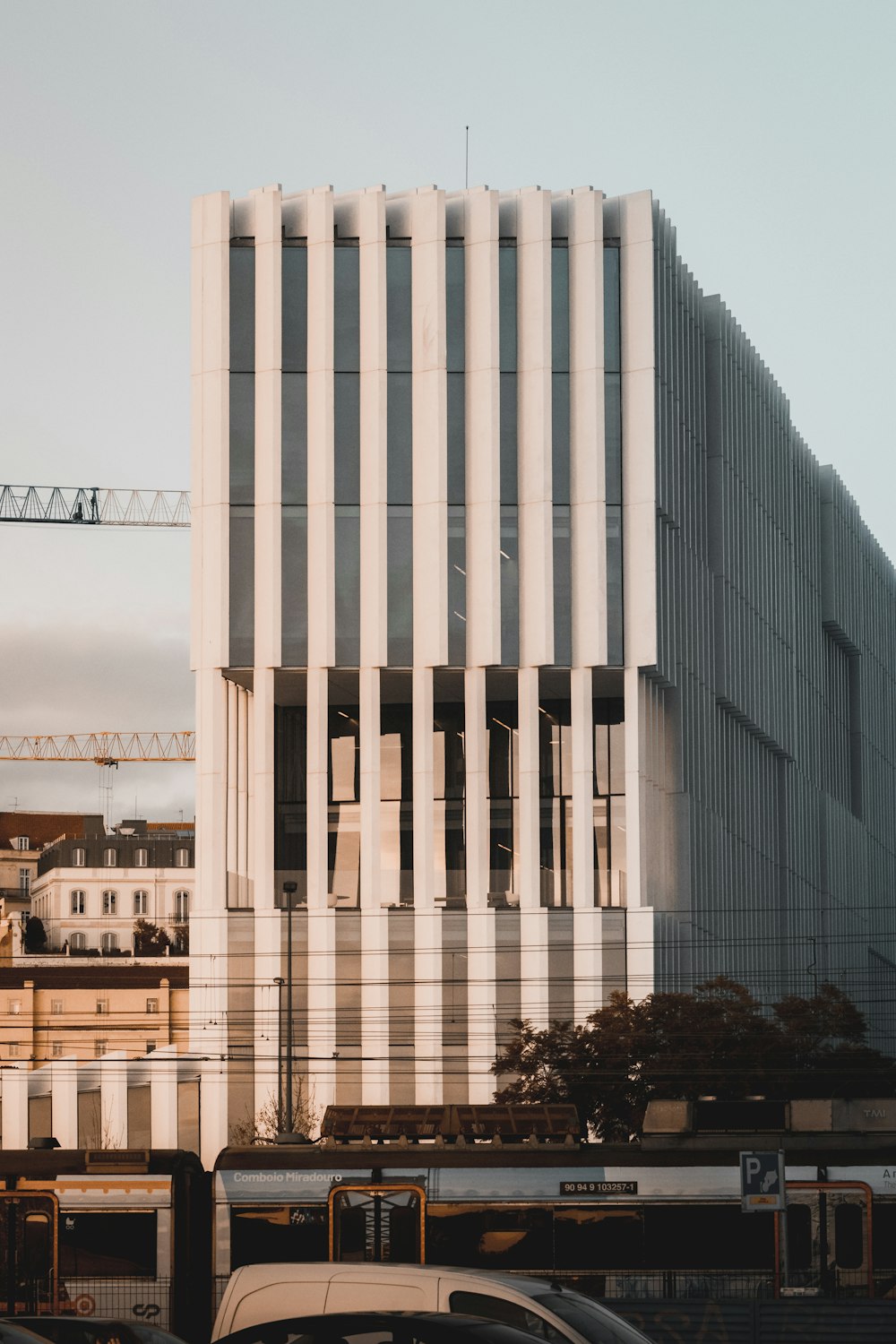 white concrete building near green trees during daytime