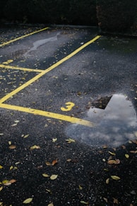 white arrow sign on gray asphalt road